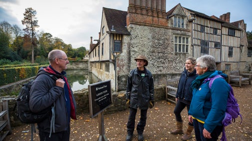 Visitors on a garden tour at Ightham Mote, Kent.